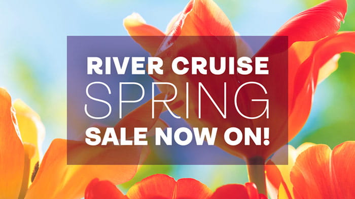 The words 'River cruise spring sale now on!' in a translucent black box overlaid on a close up image of tulips on a sunny day